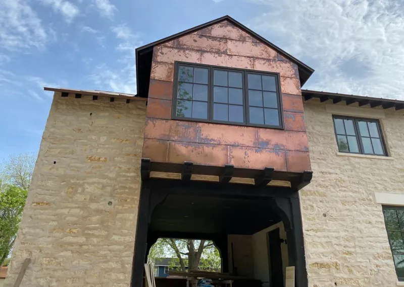 Copper metal panel facade on a stone building for Roof Repair in Cartersville